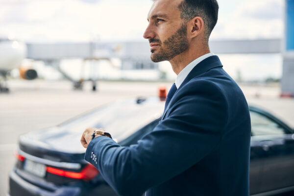 Elegant Man Lifting His Left Hand To Check The Time